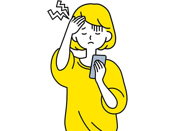 スマホの使い過ぎで頭が痛い女性